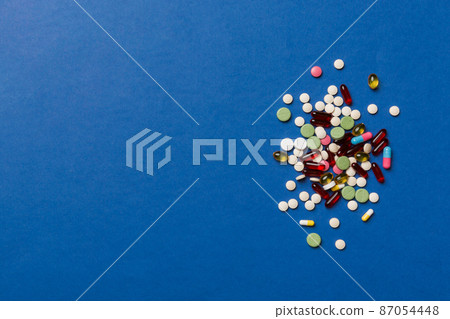 Protective face masks or surgical masks, medicine pills and thermometer on table background. Coronavirus disease. Corona virus concept. Space for text 87054448