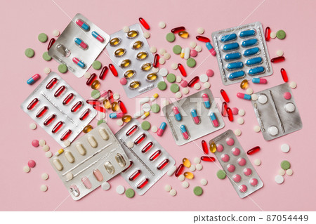 Protective face masks or surgical masks, medicine pills and thermometer on table background. Coronavirus disease. Corona virus concept. Space for text 87054449