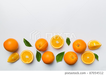 fresh Fruit orange slices on colored background. Top view. Copy Space. creative summer concept. Half of citrus in minimal flat lay with copy space fresh Fruit orange slices on colored background. Top view. Copy Space. creative summer concept. Half of citrus in minimal flat lay with copy space 87054512