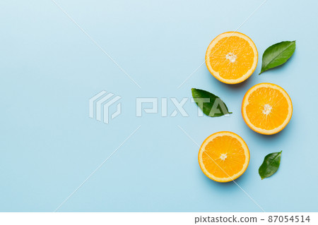 fresh Fruit orange slices on colored background. Top view. Copy Space. creative summer concept. Half of citrus in minimal flat lay with copy space fresh Fruit orange slices on colored background. Top view. Copy Space. creative summer concept. Half of citrus in minimal flat lay with copy space 87054514