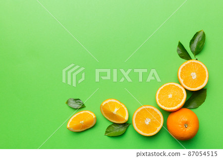 fresh Fruit orange slices on colored background. Top view. Copy Space. creative summer concept. Half of citrus in minimal flat lay with copy space fresh Fruit orange slices on colored background. Top view. Copy Space. creative summer concept. Half of citrus in minimal flat lay with copy space 87054515