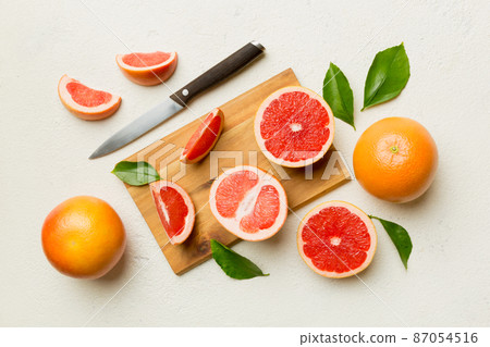 fresh Fruit grapefruit slices on colored background. Top view. Copy Space. creative summer concept. Half of citrus in minimal flat lay with copy space fresh Fruit grapefruit slices on colored background. Top view. Copy Space. creative summer concept. Half of citrus in minimal flat lay with copy space 87054516