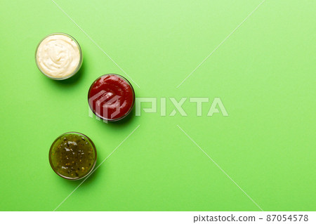 Different types of sauces in bowls on a colored Board . Top view. various sauces copy space 87054578