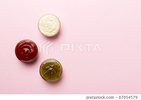 Different types of sauces in bowls on a colored Board . Top view. various sauces copy space 87054579