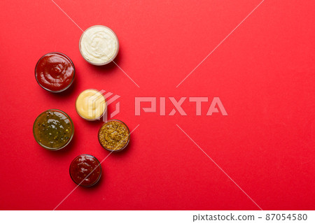 Different types of sauces in bowls on a colored Board . Top view. various sauces copy space 87054580