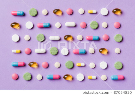 Many different pills and space for text on colorful background, top view. Different pills on color background, flat lay Many different pills and space for text on colorful background, top view. Different pills on color background, flat lay 87054830