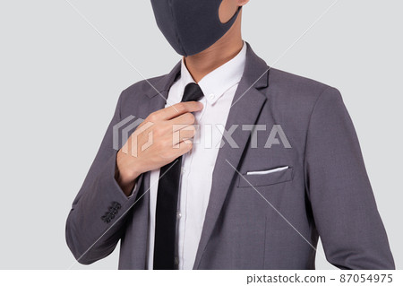 Closeup young asian businessman in suit wearing face mask for protective covid-19. Closeup young asian businessman in suit wearing face mask for protective covid-19. 87054975