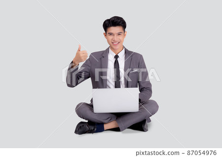 Young asian business man sitting work on laptop computer to internet online isolated. Young asian business man sitting work on laptop computer to internet online isolated. 87054976