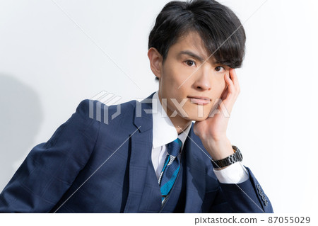 Portrait of a young man in a suit with a white background 87055029