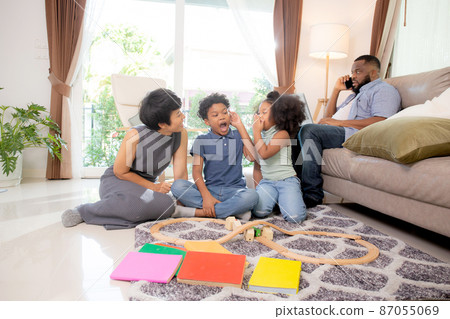 Happy family father and mother and children doing activity playing toy railway with fun. Happy family father and mother and children doing activity playing toy railway with fun. 87055069