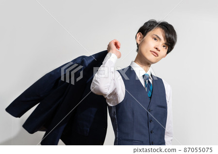 Portrait of a young man in a suit with a white background Portrait of a young man in a suit with a white background 87055075
