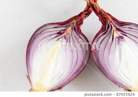 Half of Red tropea onions on a white table close up Half of Red tropea onions on a white table close up 87055924