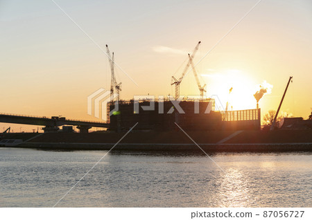 Construction site at dusk 87056727
