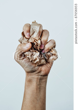 man squeezes a ball of paper 87056933