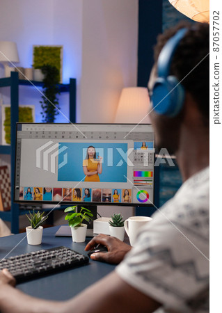 African american artist photographer with headset retouching designer pictures 87057702