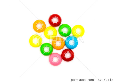 Plastic colored accessories in the form of rings for women's creativity on a white background Plastic colored accessories in the form of rings for women's creativity on a white background 87059418