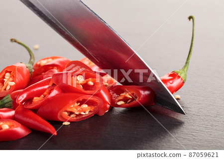 Knife and red chilli pepper. Knife and red chilli pepper. 87059621