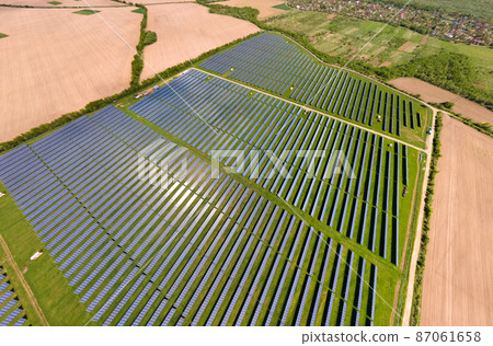 Aerial view of big sustainable electric power plant with many rows of solar photovoltaic panels for producing clean ecological electrical energy. Renewable electricity with zero emission concept. 87061658