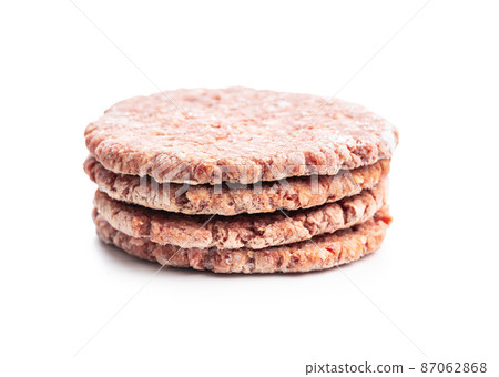 Frozen hamburger meat. Raw beef patties isolated on white background. Frozen hamburger meat. Raw beef patties isolated on white background. 87062868