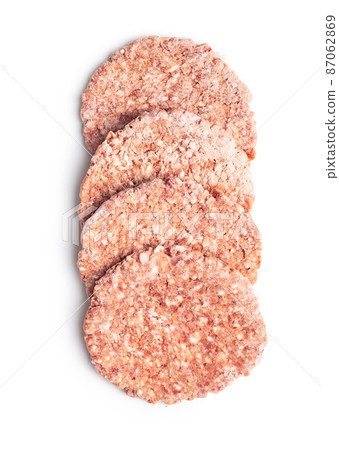 Frozen hamburger meat. Raw beef patties isolated on white background. Frozen hamburger meat. Raw beef patties isolated on white background. 87062869