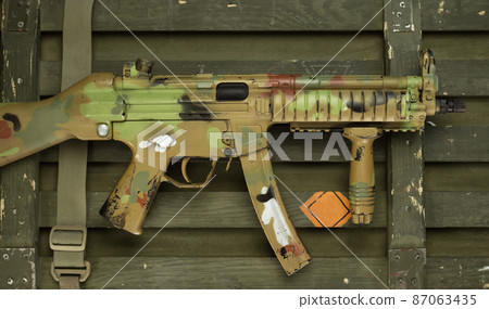 mp5 automatic rifle next to ammunition box and other military accessories mp5 automatic rifle next to ammunition box and other military accessories 87063435