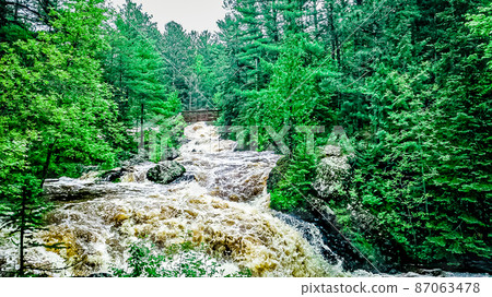 Natural waterfalls in nature with vibrant trees Natural waterfalls in nature with vibrant trees 87063478