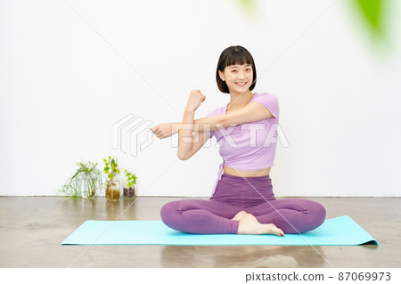 Women doing yoga and flexibility exercises Women doing yoga and flexibility exercises 87069973