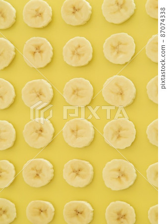Banana slices lined up on one side Vertical composition 87074338