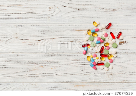 Protective face masks or surgical masks, medicine pills and thermometer on table background. Coronavirus disease. Corona virus concept. Space for text 87074539