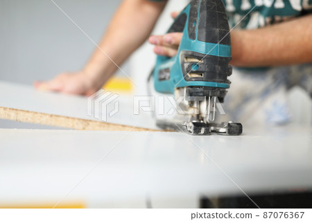 Man using tool for work Man using tool for work 87076367