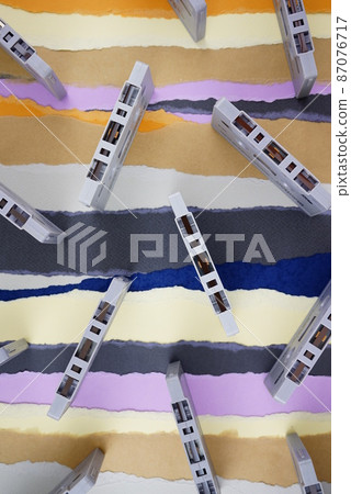 Cassette tapes, classic vintage antique nostalgia flat lay on torn colored paper background. 87076717