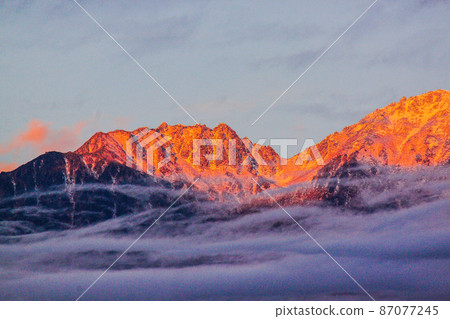 Morgenroth between the clouds in the Central Alps Sengairei Morgenroth between the clouds in the Central Alps Sengairei 87077245