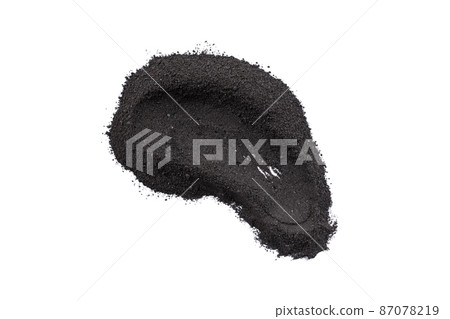 Dry black cosmetic clay smear isolated on white background. Abstract sample of black charcoal cosmetic clay. 87078219