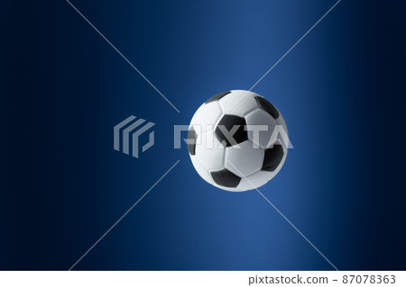 Traditional soccer ball flying over blue background. 87078363