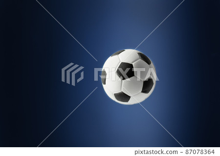 Traditional soccer ball flying over blue background. 87078364