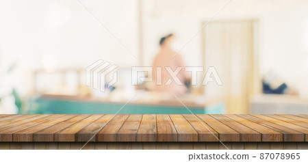 Wooden table top with blurred people in coffee shop and cafe background for display montage, copy space. Wooden table top with blurred people in coffee shop and cafe background for display montage, copy space. 87078965