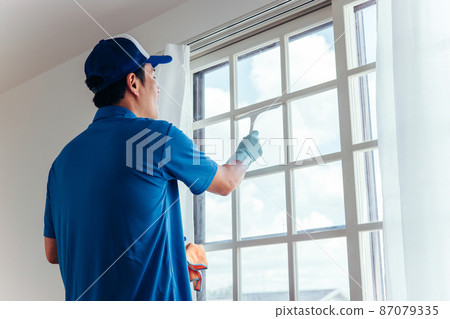Men in work clothes cleaning windows Men in work clothes cleaning windows 87079335