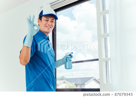 Men in work clothes cleaning windows 87079343