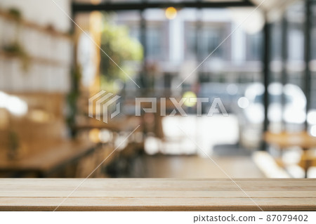 Empty wooden table in front of blurred background of coffee shop. Copy space for display or montage your products. 87079402