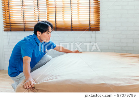 Men in work clothes making beds and cleaning rooms 87079799