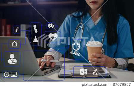 Medical students use mobile phones to search for information in a modern office in the morning at the desk. 87079897