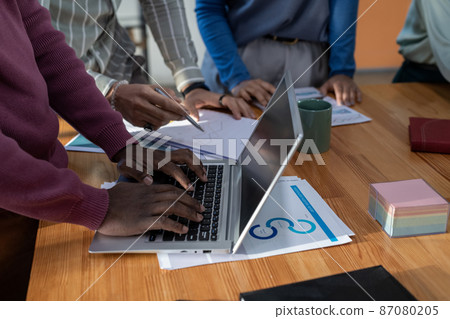 Hands of African-American businessman typing on laptop keyboard Hands of African-American businessman typing on laptop keyboard 87080205