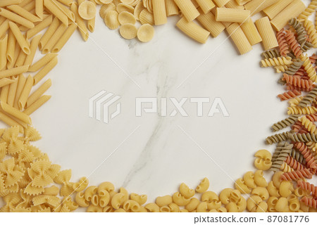 pasta concept different kinds of dry pasta being sorted into groups and placed in circle on the white background 87081776
