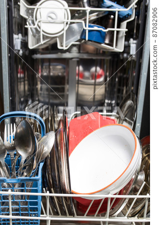 Dishwasher with dirty dishes closeup. Household kitchen appliances. Assistant hostess. Dishwasher with dirty dishes closeup. Household kitchen appliances. Assistant hostess. 87082906
