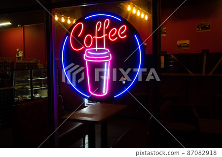 Coffee inscription glows neon sign close-up. Coffee inscription glows neon sign close-up. 87082918