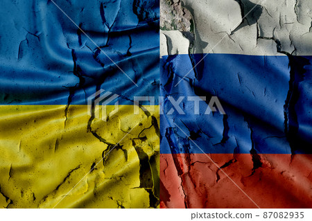Flag of Russia and Ukraine on a destroyed wall close-up. Conflict of countries and the threat of war. Flag of Russia and Ukraine on a destroyed wall close-up. Conflict of countries and the threat of war. 87082935