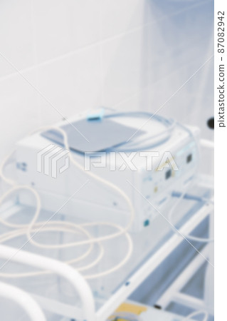 Blurry empty interior operating room and modern equipment in hospital.Medical device for surgeon surgical emergency patient in blue tone style.Save life medical treatment concept. Blurry empty interior operating room and modern equipment in hospital.Medical device for surgeon surgical emergency patient in blue tone style.Save life medical treatment concept. 87082942