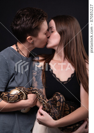 Photo of two kissing women with pythons 87085227