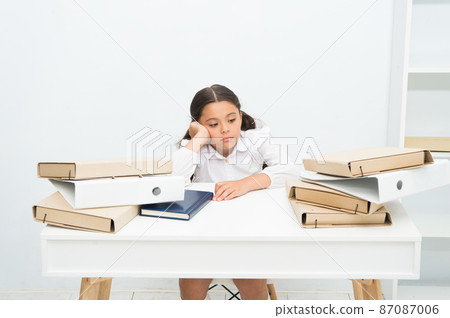 Too much to learn. Girl child tired exhausted sit at table  87087006