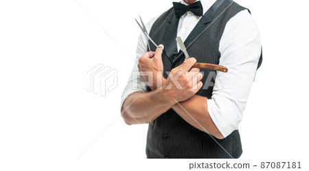 cropped man hairdresser with razor blade and scissors in bow tie isolated on white with copy space. 87087181